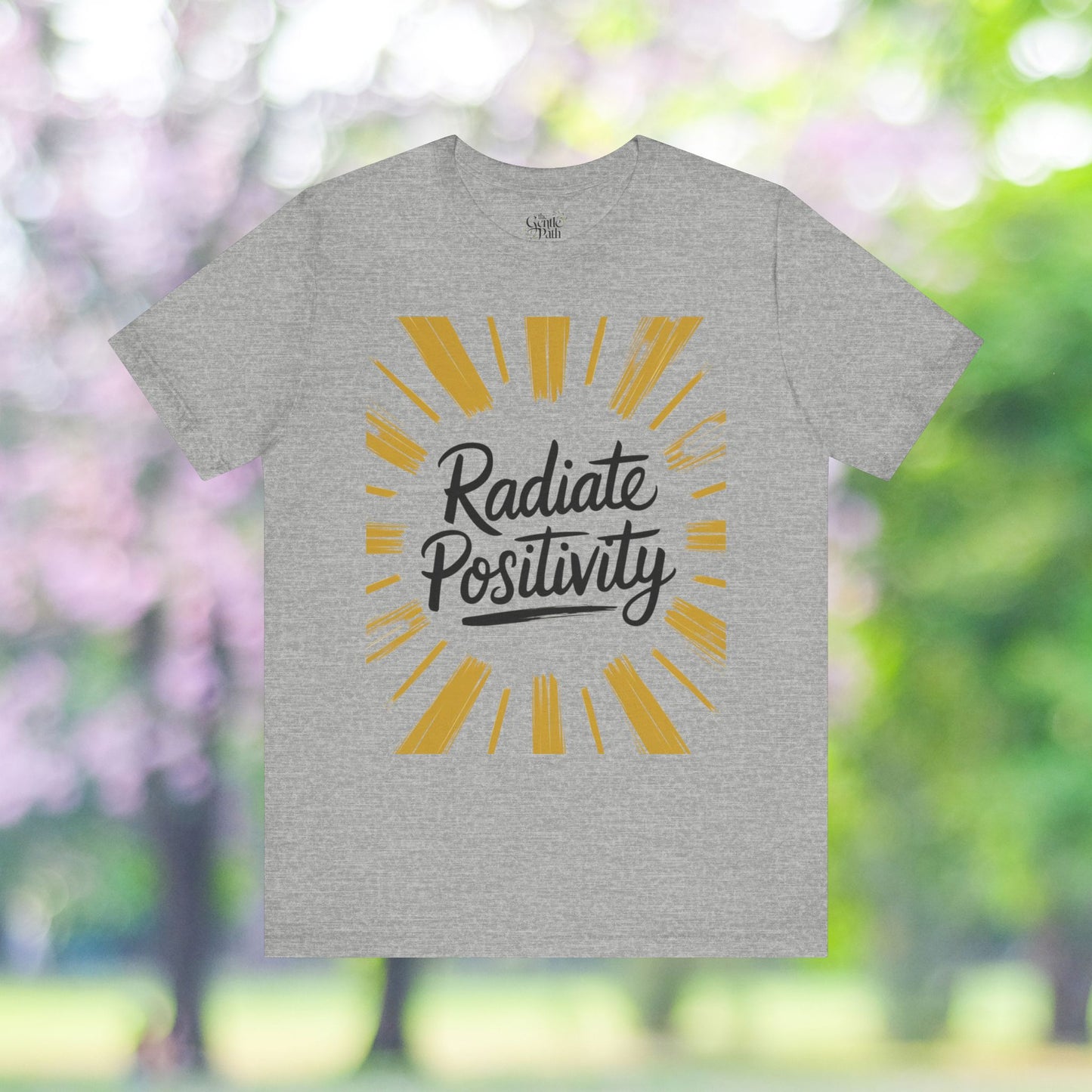 Grey tee with 'Radiate Positivity' graphic design.