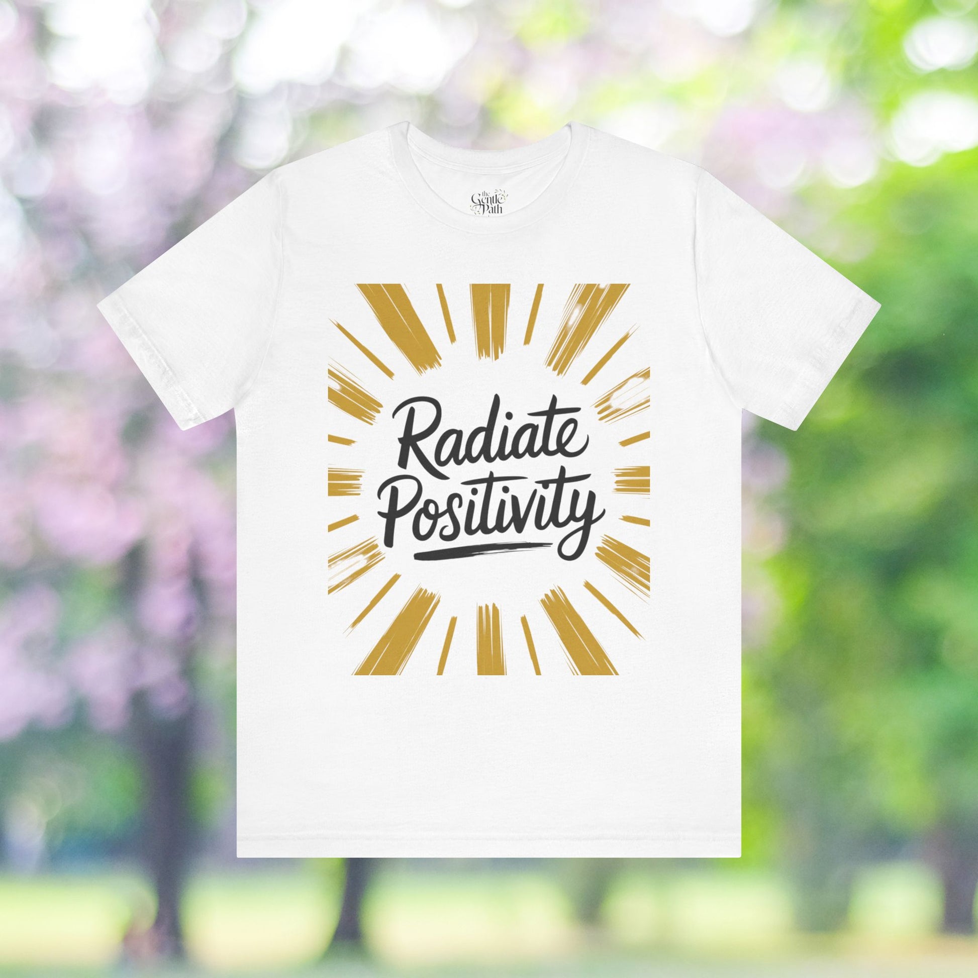 White t-shirt with radiate positivity graphic design.