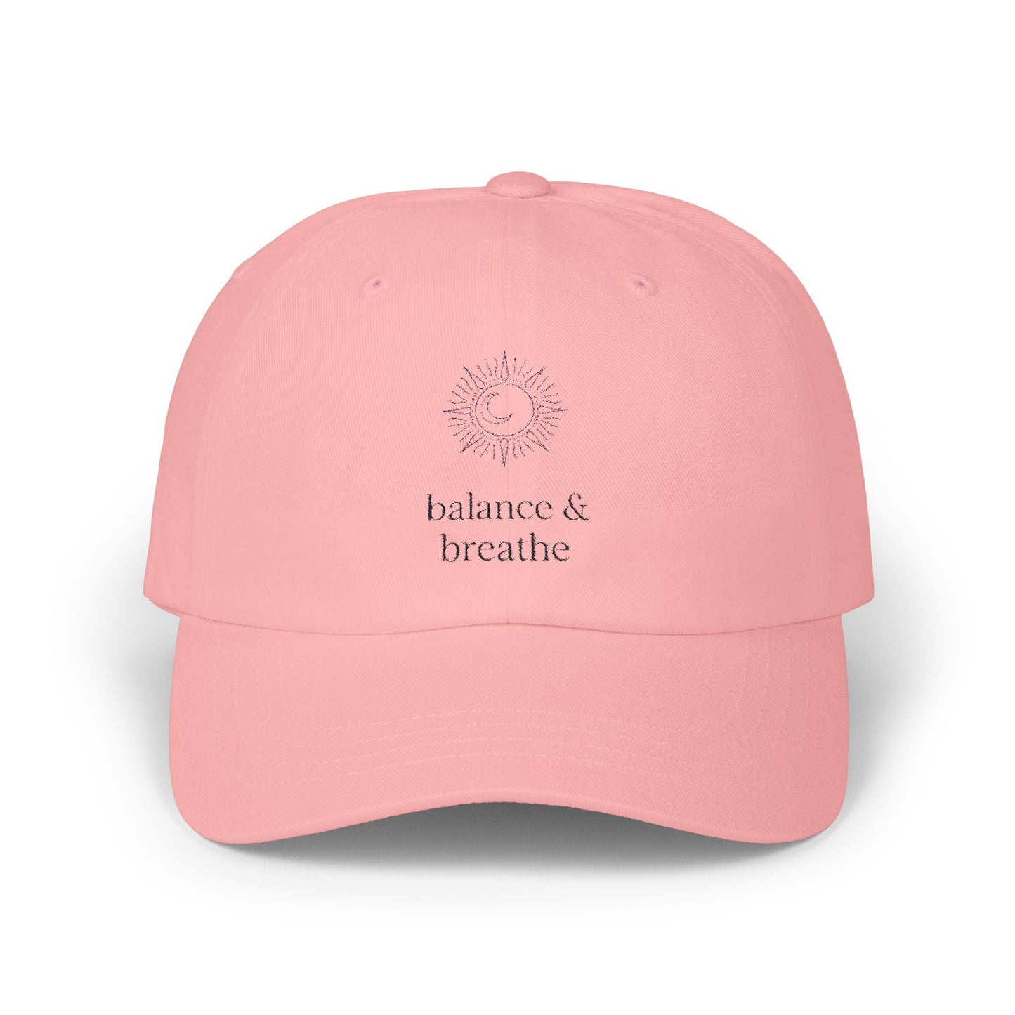 Pink hat with celestial embroidery and 'balance & breathe' text.