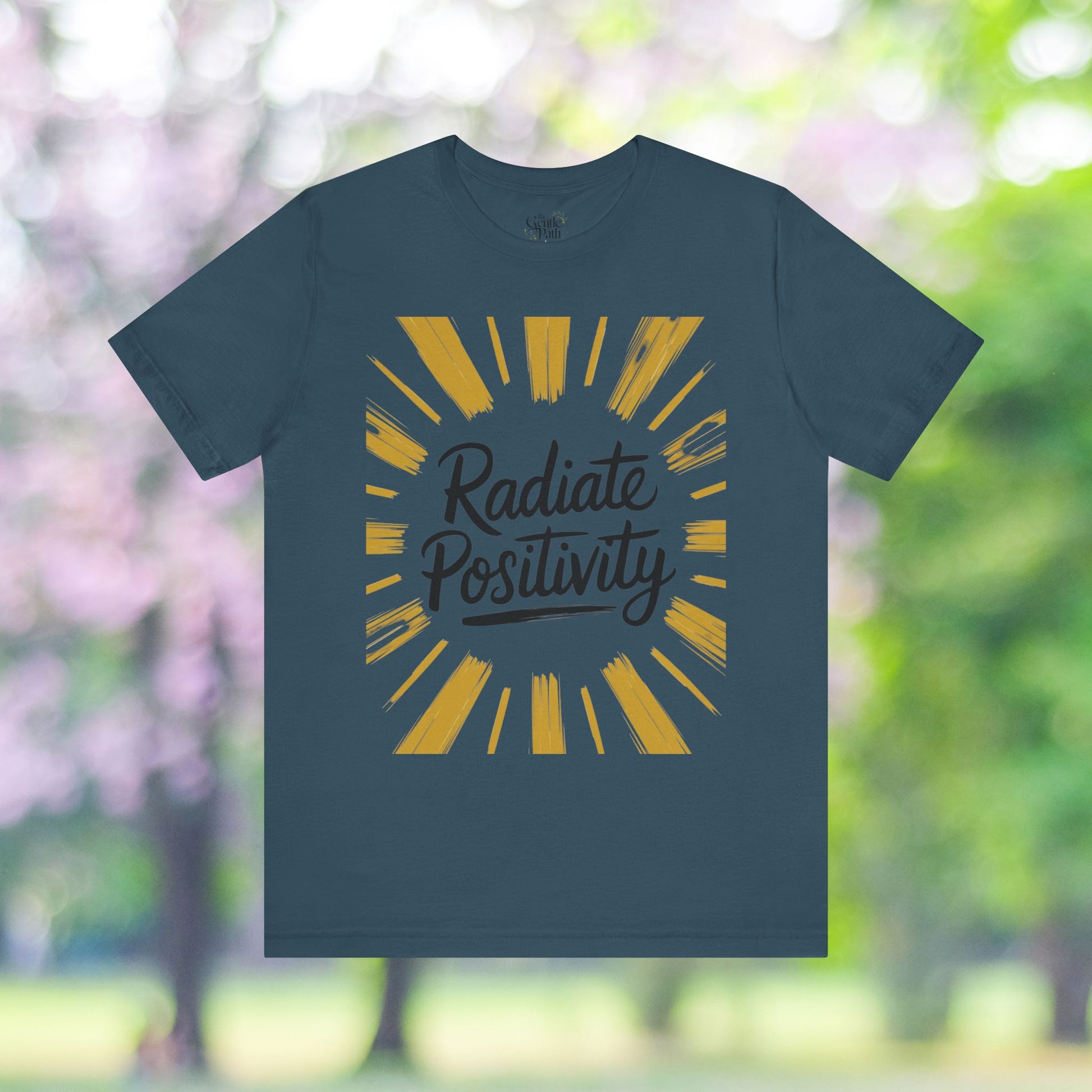 Radiate Positivity tee with sunburst design.