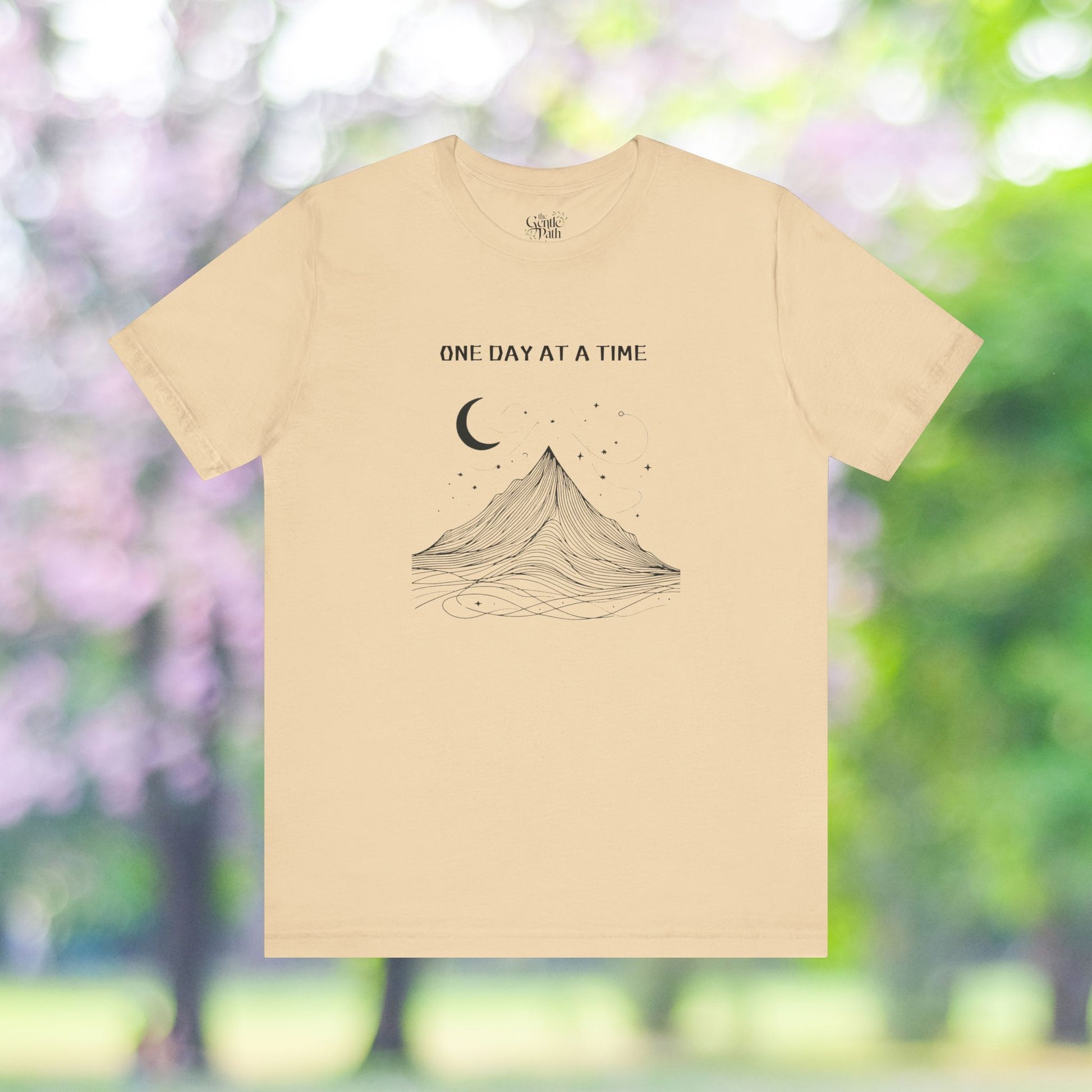 Minimalist mountain tee with moon design and One Day At A Time text.