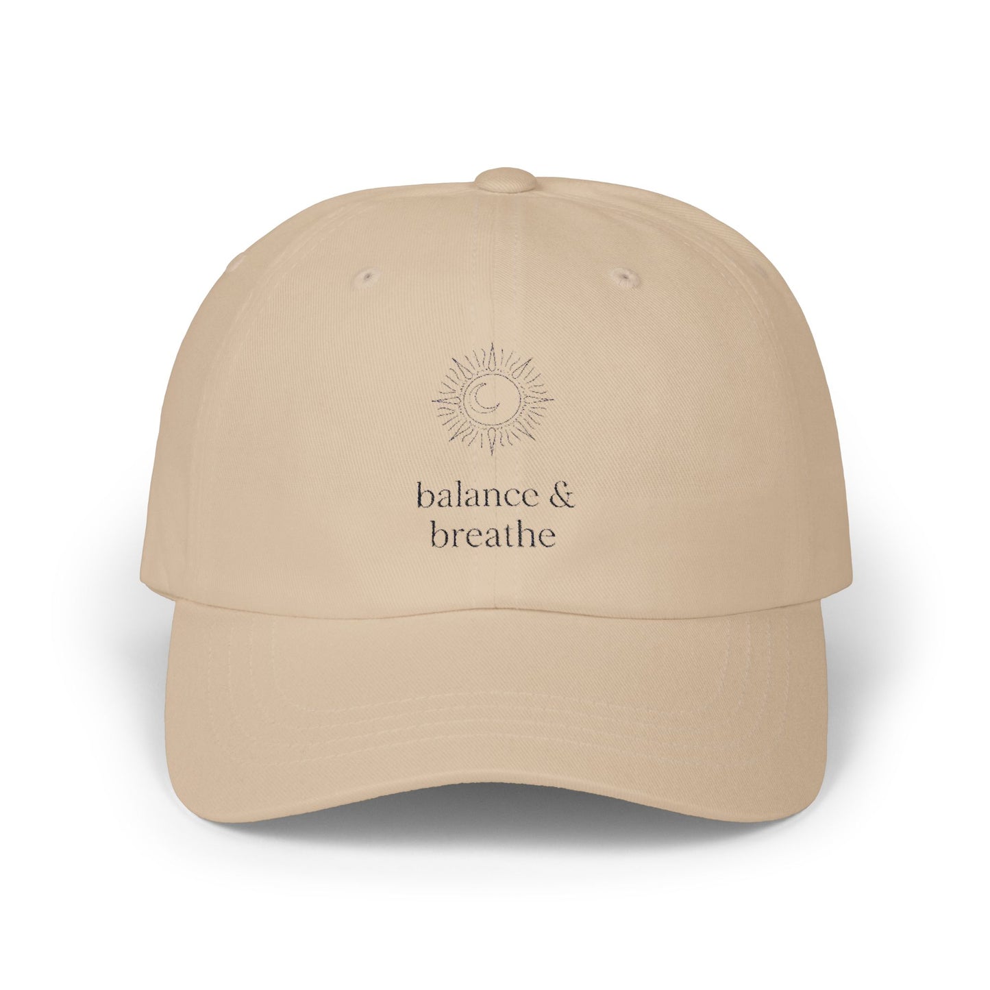 Beige hat with celestial embroidery and 'balance & breathe' text.