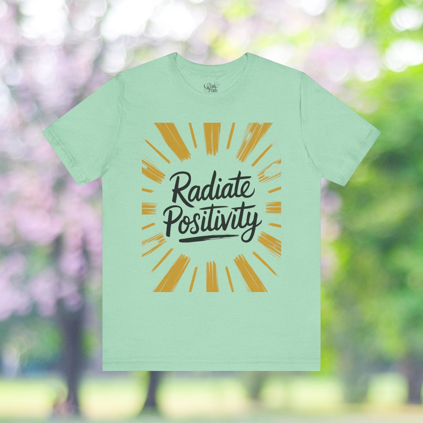 Green tee featuring 'Radiate Positivity' graphic design.