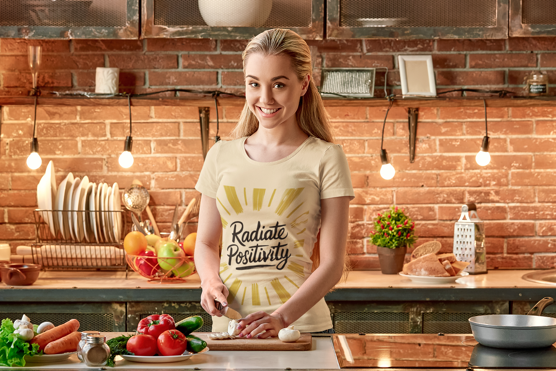 Woman wears positivity tee while cooking in her kitchen