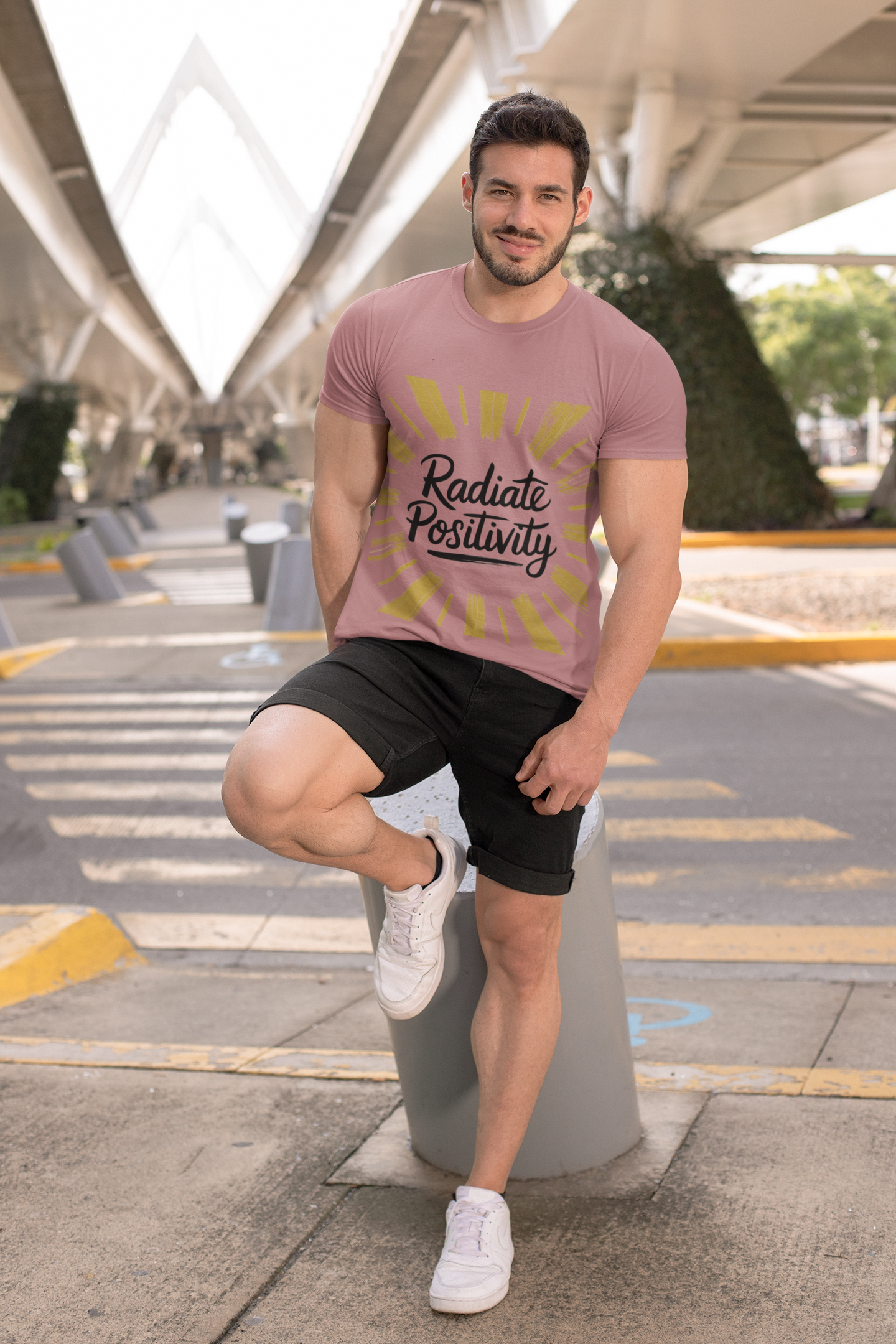 Man wears Radiate Positivity Tee with positive graphic design.