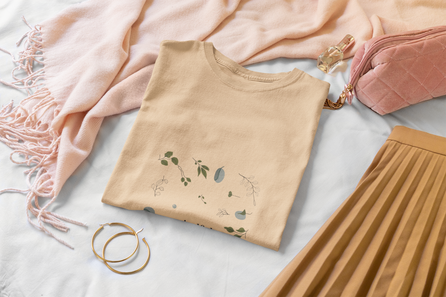 Beige t-shirt with a botanical design and styled with a scarf and skirt.