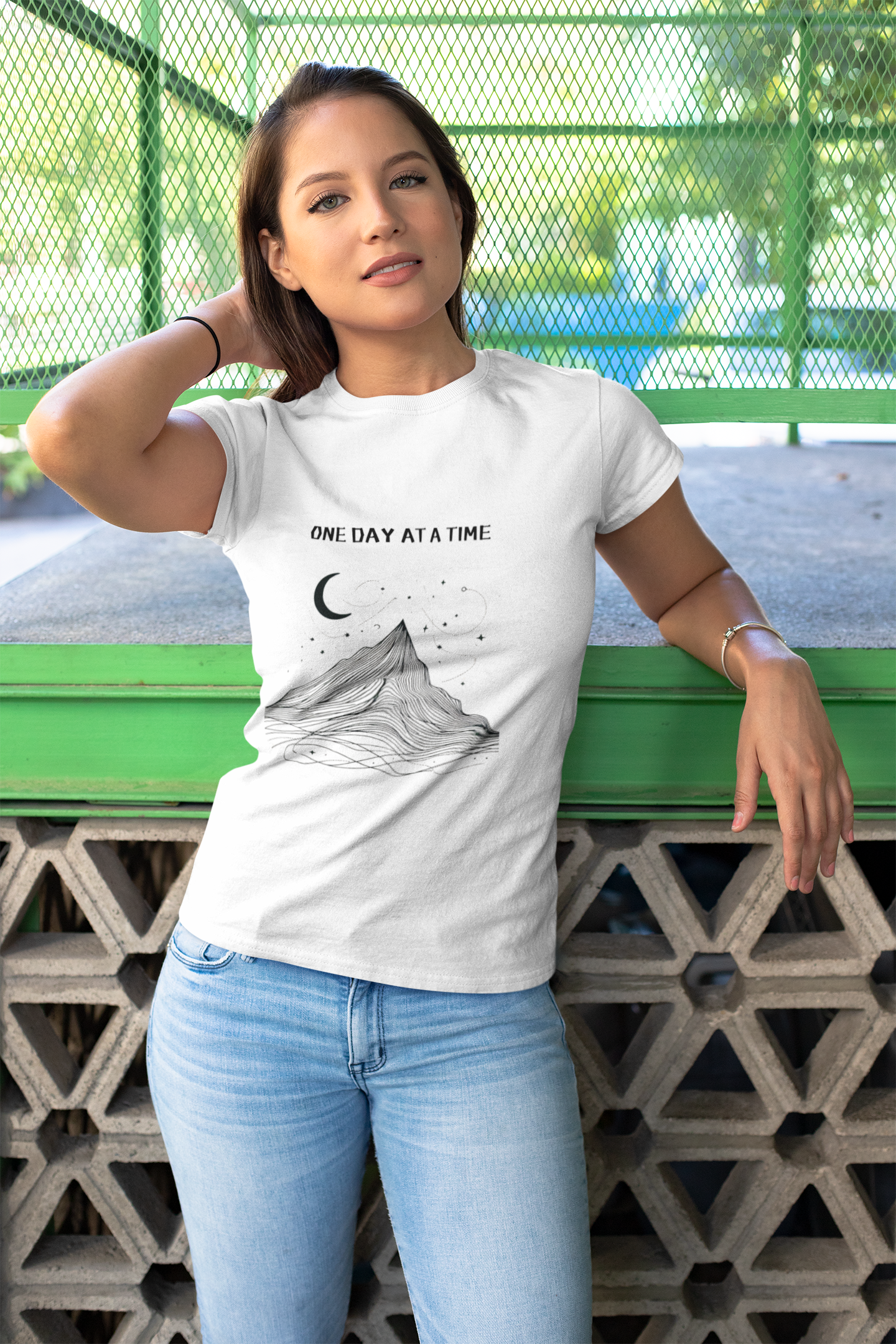 Minimalist tee with mountain and moon design, reads 'One Day At A Time'