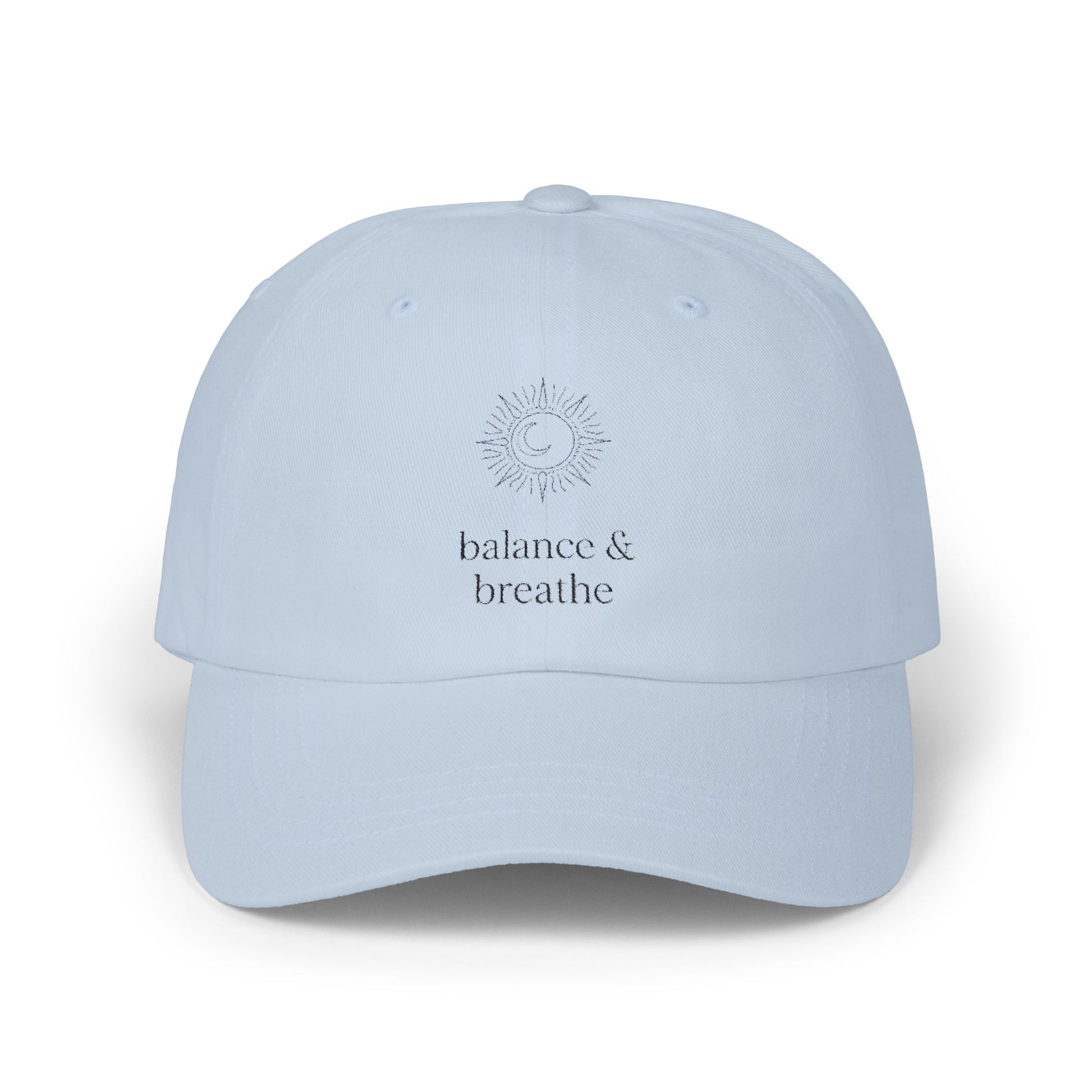 Light blue hat with celestial embroidery and 'balance & breathe' text.